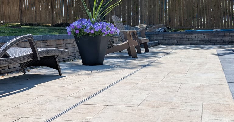 Pool Deck made from patio pavers with slot drain installed for pool deck drainage